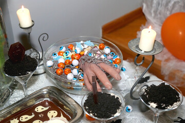 Halloween themed snacks, desserts and decor. Selective focus.