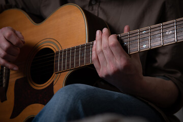 Fototapeta premium Person playing acoustic guitar