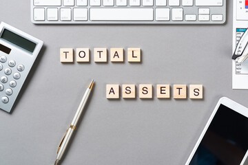 Total assets concept with letters on cubes