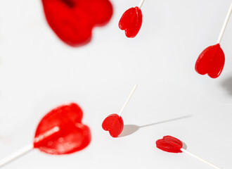 red heart shaped lollipop on white background