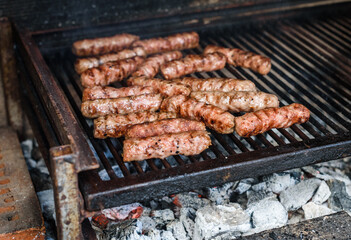 Grilling Meat on barbecue grill with hot coal.