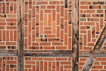 Stone wall made of bricks with wooden beams