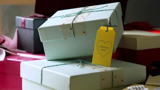 Gift box with ribbon and greeting tag . High angle view