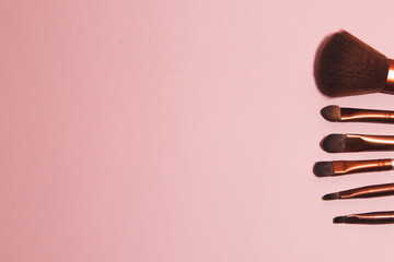 makeup brushes on pink background
