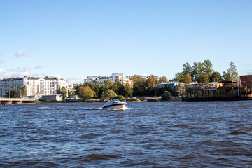 Fototapeta premium Photos of the city river with a boat in sunny weather