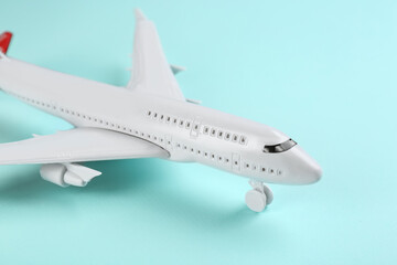 Toy airplane on light blue background, closeup