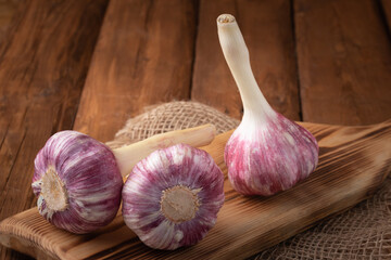 Eco vegetables - red garlic on wooden background, vegan food
