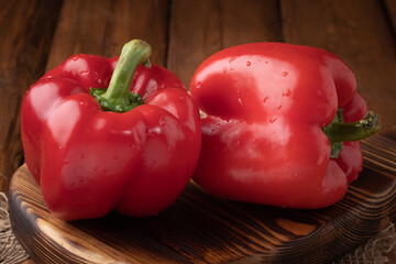 Eco vegetables - fresh red peppers on wooden background, vegan food