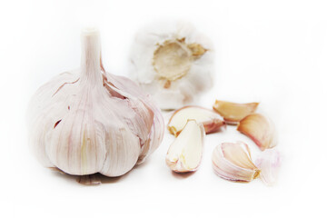 Organic garlic. Fresh garlic cloves and garlic bulb isolated on a white background. Garlic for healthy eating. Closeup