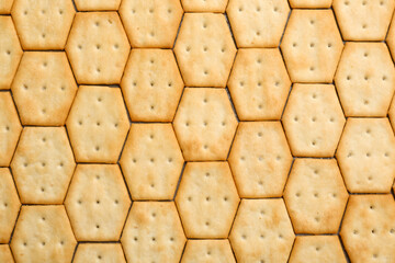 Many delicious crackers as background, top view