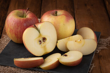 Naklejka na ściany i meble Eco fruits - fresh red apples on wooden background, vegan food