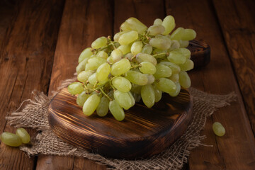 Eco fruit - fresh green grapes on wooden background, vegan food