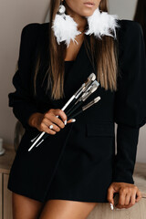 Business woman. Girl artist, holds brushes.