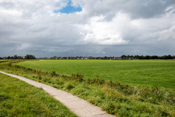 Landscape photo of the beautiful flat Groningen farmers land in summer time, the Netherlands