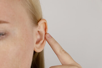 Darwin's tubercle on the ear. The girl at the reception at the plastic surgeon, shows the auricle.
