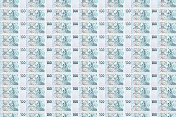 100 Czech korun bills printed in money production conveyor. Collage of many bills. Concept of...