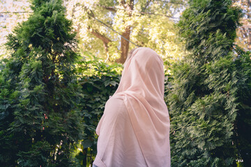 Autumn. Lonely muslim woman in a headscarf  walking in a park, garden. Vintage Toned