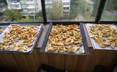 Chopped apples to dry on the balcony at home. Apple harvest and processing. Selective focus, shallow depth of field