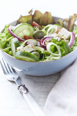 Salad with Green Olives, Cucumber and Feta Cheese. Bright wooden background.	