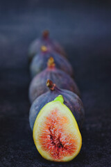 Fresh ripe purple figs on the table. Black background. Top view. Flat lay. Healthy food concept.  Organic. 