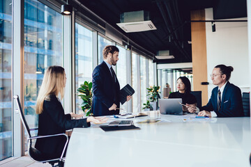 Multiracial formal business people gathering on briefing in office