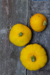 Yellow pumpkins on rustic gray wooden background