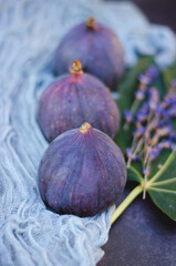 Fresh ripe figs on the table with flowers of lavender. Top view. Flat lay. 