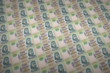 200 Hungarian forint bills printed in illegal money production conveyor. Collage of many fake...