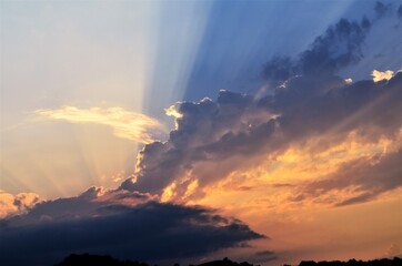 Obraz na płótnie Canvas through a dark cloud, the sun's rays make their way, after the rain
