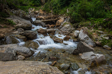 Naklejka na ściany i meble little brook with rocks in the nature while hiking