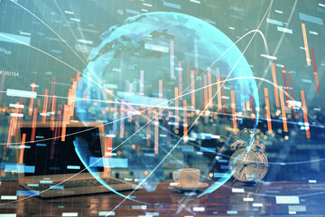 Double exposure of graph and financial info and work space with computer background. Concept of international online trading.