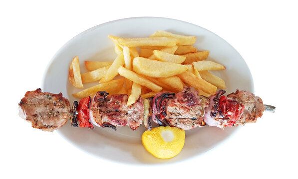  souvlaki and potatoes with lemon in plate