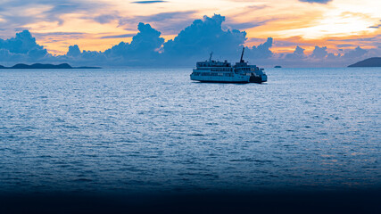 Ferry boat sails to the islands by sea at colorful dawn