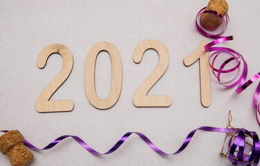 Light wooden numbers 2021 lie on a white background with