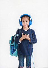 Portrait Smiling asian little child girl enjoy with smartphone and headphones isolated on white background.