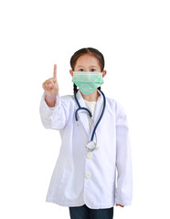 Obraz na płótnie Canvas Portrait asian little child girl in doctor's uniform with stethoscope and wearing medical mask showing one forefinger isolated on white background. Focus at his face.