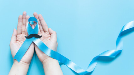 Men's health and Prostate cancer awareness campaign in November. Man hands holding light blue...
