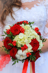 bride holding bouquet of roses