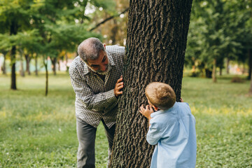 boy with his grandfather playing in city park