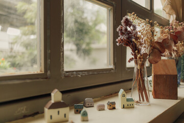 Small house decorated on the edge of windows in the cafe.
