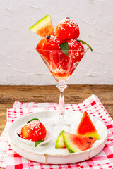 Sweet watermelon ice cream with coconut flakes and fresh basil leaves