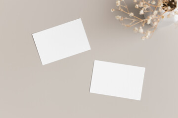 Two white business cards mockup with gypsophila. 85x55mm