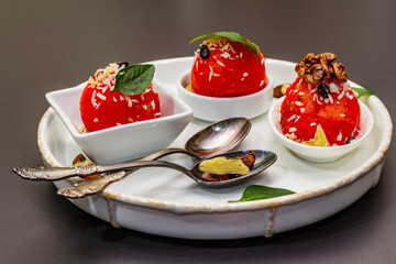 Watermelon ice cream or sorbet with coconut flakes, walnuts and fresh basil leaves