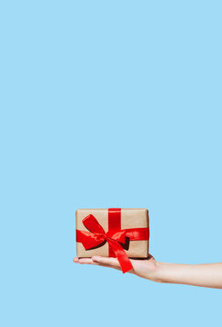 A woman's hand holds a New Year's gift