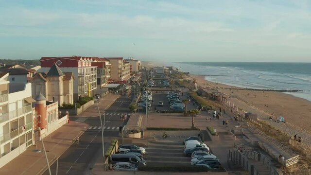 Small Beach Town Village Lacanau Promenade in South of France at Sunset, Slow Aerial high angle forward