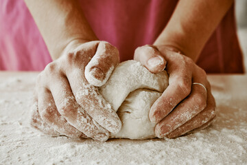 Fototapeta na wymiar hands kneading dough, baker, the Baker's hands, dough, hands in the flour, dumplings, handmade dumplings