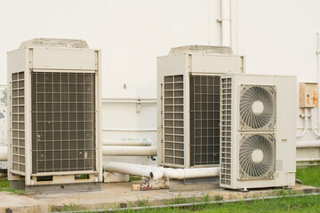 Close up Air conditioning out door, A group of three industrial sized air conditioners along a...