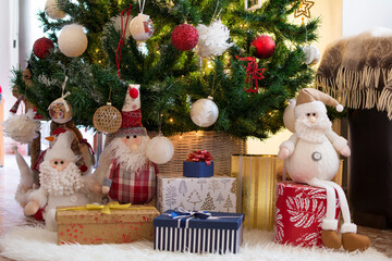 Dolls, gifts and surprises on a white carpet, under the Christmas tree.