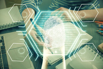 Blue fingerprint hologram over hands taking notes background. Concept of security. Double exposure