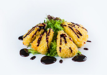 Fried cheese pieces served on salad mix with sauce isolated on white background. Fast food menu isolation 